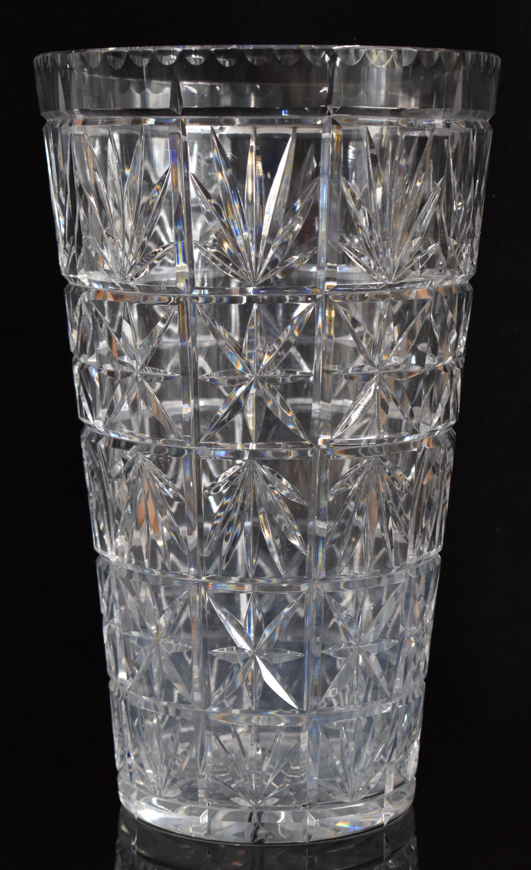 A large cut glass vase with star cut base, 36cm tall.