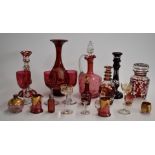 A collection of cranberry overlaid and cut glass items including a hallmarked silver mounted scent