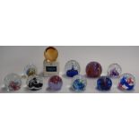 Eleven Caithness glass paperweights including Reflections, Fiesta, Starlight, Millennium Miniature