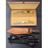 A cased pair of Ka-Bar folding pocket knives, Ka-Bar Bowie knife with 21cm blade and leather