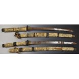 Two Japanese short swords with ornately carved bone handles and scabbards, overall length 85cm