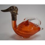 A pedestal glass figural duck claret jug with white metal mount, the hinged duck head folding back