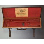 Holland & Holland leather bound wooden shotgun case with fitted interior, brass corners and original