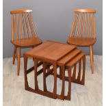 A pair of Ercol style beech stick back chairs and a retro set of three nest of three teak tables,