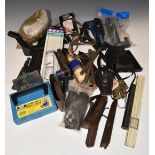 A collection of gun parts and accessories including air rifle sound moderators, springs, bullet