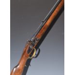 Mendi flintlock Kentucky style rifle with brass scrolling spurred trigger guard, butt plate and