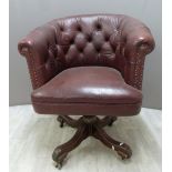 A vintage leather Chesterfield swivel / office chair with button back and wooden base, H87cm