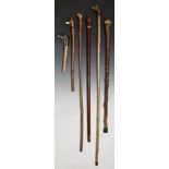 Six shooting and walking stick and walking stick handles, two with finials carved in the form of