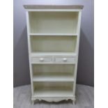 A painted dresser with four shelves, two central drawers and carved decoration W90 X D35 X H180cm