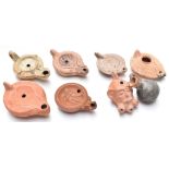 Seven Roman / Roman style terracotta oil lamps, length of longest 13cm and a Roman vase