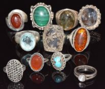 Eleven silver rings set with turquoise, agate, amber, malachite, moonstone, marcasite, etc