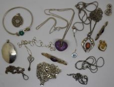 A collection of silver jewellery including brooches, locket, pendants, chains, curb link necklace,