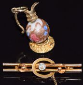 Edwardian 9ct gold brooch (2.3g) and a 9ct gold charm in the form of a jug set with a glass bead