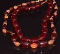 A cherry amber necklace and a necklace of alternating carnelian agate and cherry amber beads,  135g