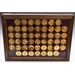 Cased set of gold plated bronze medallions 'The World's Greatest Sculptures' in glazed display case,