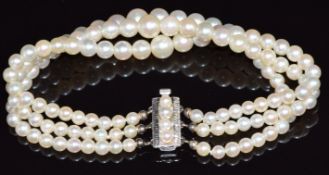 Three strand cultured pearl bracelet with 14k white gold clasp set with further pearls
