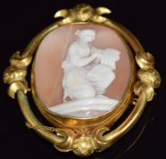 Victorian pinchbeck brooch set with a cameo of a young woman reading, verso a glass compartment, 6 x