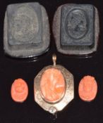 A yellow metal pendant set with a carved cameo and diamond, two miniature carved coral cameos and