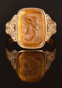 A 9ct gold ring set with a tiger's eye cameo, size T, 5.3g