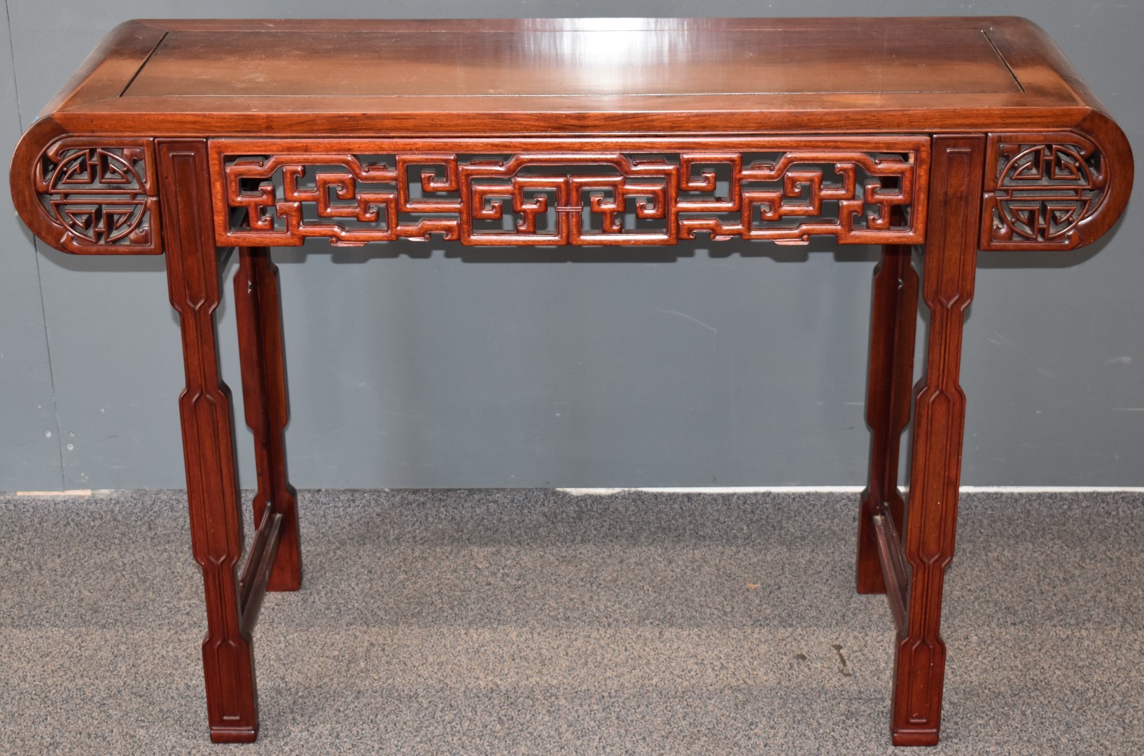 Carved oriental hardwood altar table with carved decoration, W127 x D43 x H83cm
