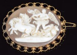 A yellow metal c1900 brooch set with a cameo depicting horses and a cherub, 5 x 4cm