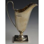 George V hallmarked silver jug of helmet shape raised on square base, Sheffield 1935, maker Viner'