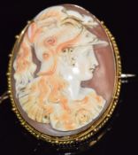 A yellow metal brooch set with a cameo depicting a classical figure, 3.5 x 4cm