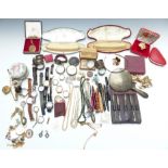 A collection of costume jewellery including silver napkin rings, silver handled manicure set,