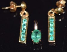 A 9k gold pendant set with an oval cut emerald (0.7g) and a pair of 9ct gold earrings set with