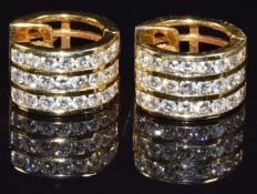 A pair of 18ct gold earrings set with three rows of diamonds to each, total diamond weight