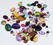 A collection of loose gemstones including paste, amethyst, garnet, peridot, etc