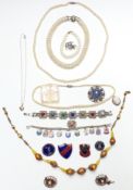 A collection of jewellery including lucite brooch, vintage hockey badge, silver locket, silver charm