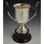 George V hallmarked silver twin handled trophy cup with lion mask handles, inscribed for the