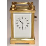 A c1930s brass carriage clock with reeded decoration to corners, H11.5cm
