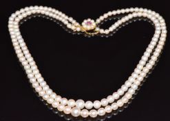 A double strand cultured pearl necklace with 9ct gold clasp set with an amethyst and pearls