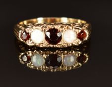 A 9ct gold ring set with opals and garnets, size R, 4.1g