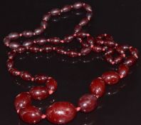 A cherry amber necklace made up of graduated oval beads, 60g