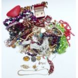 A collection of costume jewellery including vintage beads, spider brooch, Sarah Coventry brooch,