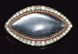 Victorian marquise shape brooch set with paste within a border of sphere decoration, with glass