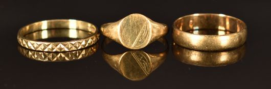 A 9ct gold signet ring (size H, 0.8g) and two 9ct gold rings (one set with diamonds), sizes K and