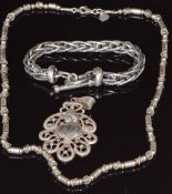 A silver necklace by Megido, silver bracelet and white metal pendant