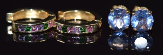 Two pairs of 9k gold earrings, one pair set with purple sapphires and tsavorite garnets and the