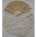 A 19thC carved bone and lace fan and a circular piece of lace, L22.5cm