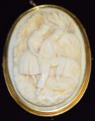 A c1900 yellow metal brooch set with an carved ivory cameo of a young couple, 5 x 3.5cm