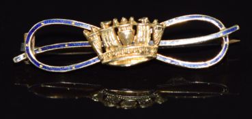A 15ct gold brooch in the form of a coronet on blue enamel set bow, 3.5g