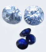 Two loose round cut pale blue sapphires and three further sapphires