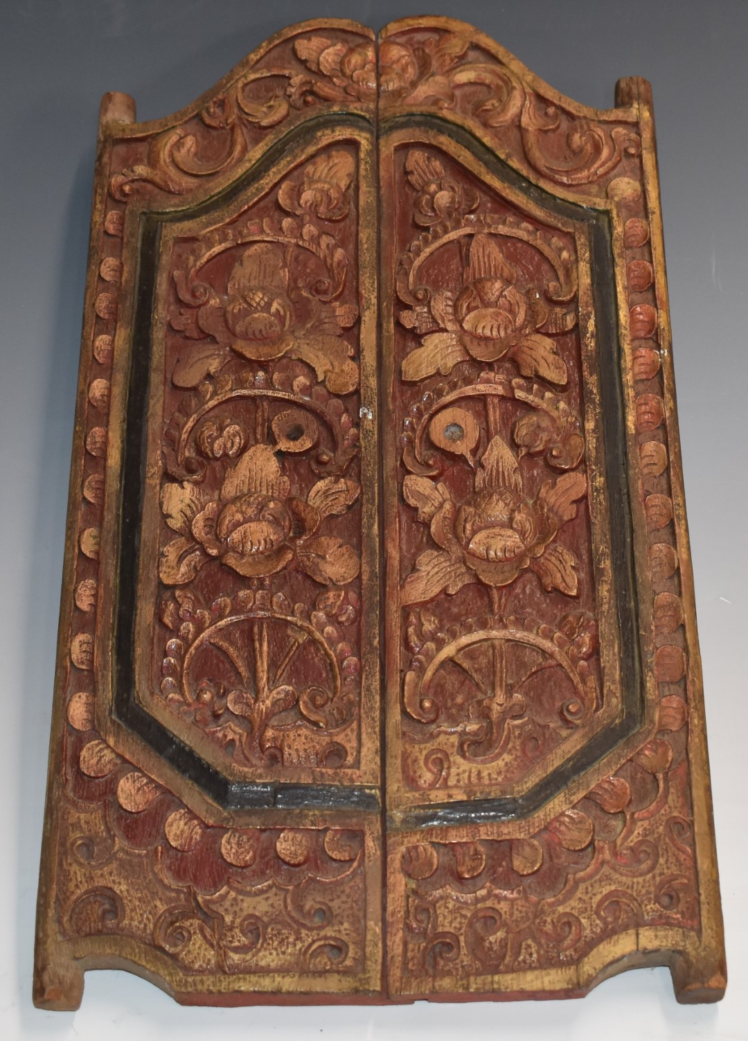 A carved hardwood door, possibly door peephole within a door, H46 x W25cm