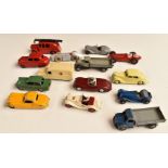 Fourteen Dinky Toys diecast model vehicles including MG Midget, Triumph Herald and Daimler