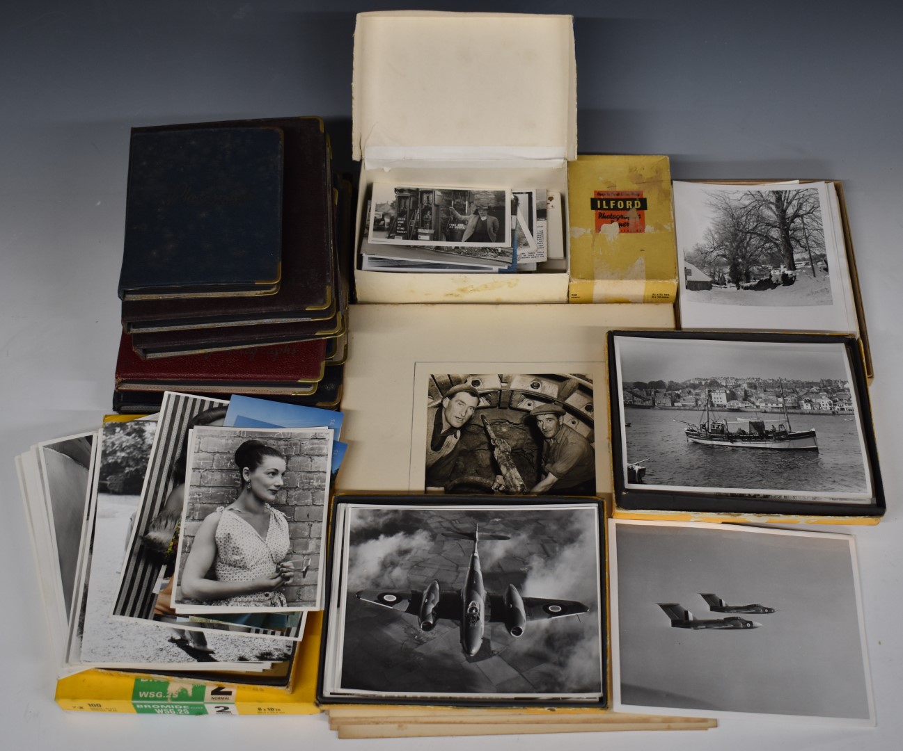 A large collection of c1950s photographs, loose and in albums, including glamour, vintage