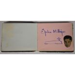 Autograph album containing a drawing and signature by Spike Milligan, other autographs include